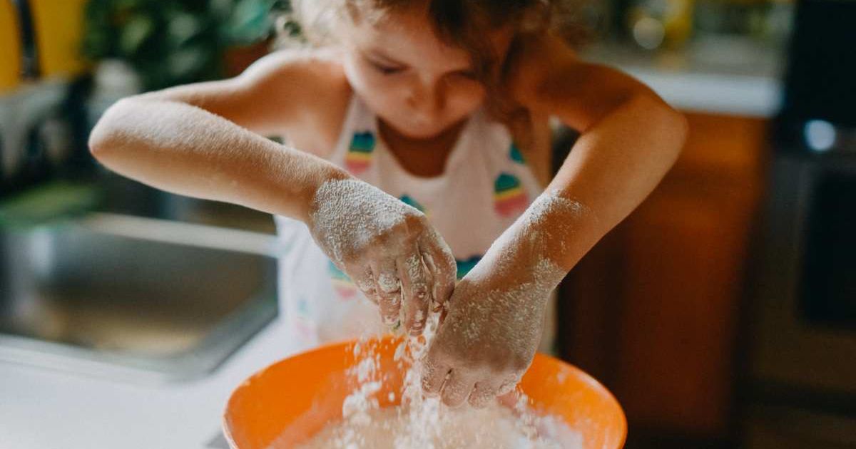 A little girl kneads the flour while baking bread (Representative Cover Image Source: Getty Images | Stefania Pelfini, La Waziya Photography)
